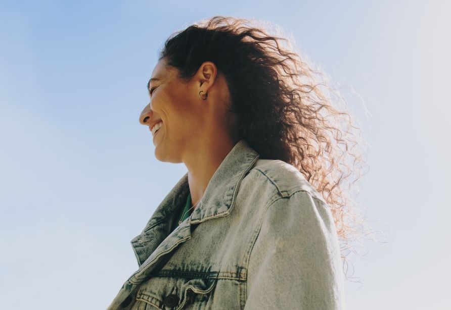 Leende kvinde if�rt cowboyjakke udend�rs.